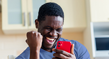 Man excited and looking at his phone